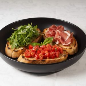 Bruschetas con rúcula, tomate y jamón crudo